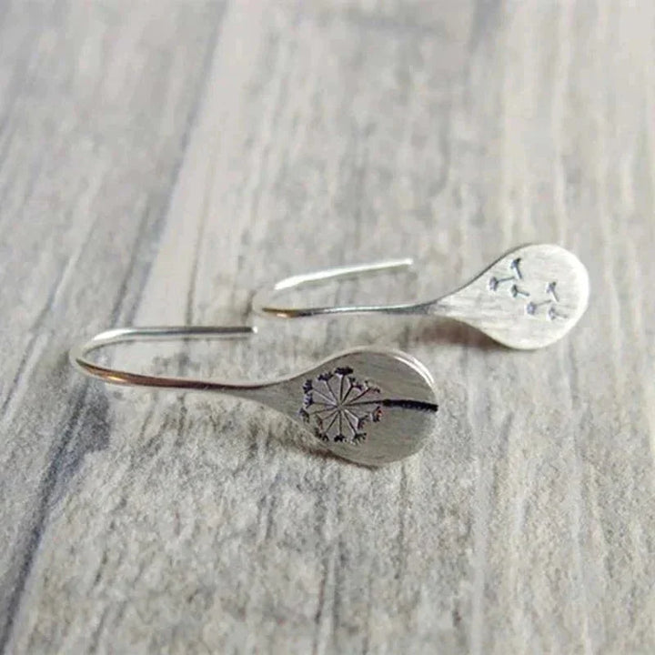 Beautiful sterling silver women's dangle earrings, teardrop shape with real dandelion seeds, nature-inspired jewelry.