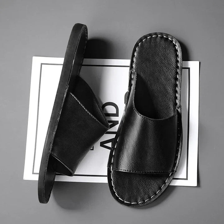 Close-up of women's comfortable stitched flat open-toe sandals. Ideal casual slip-on summer footwear.
