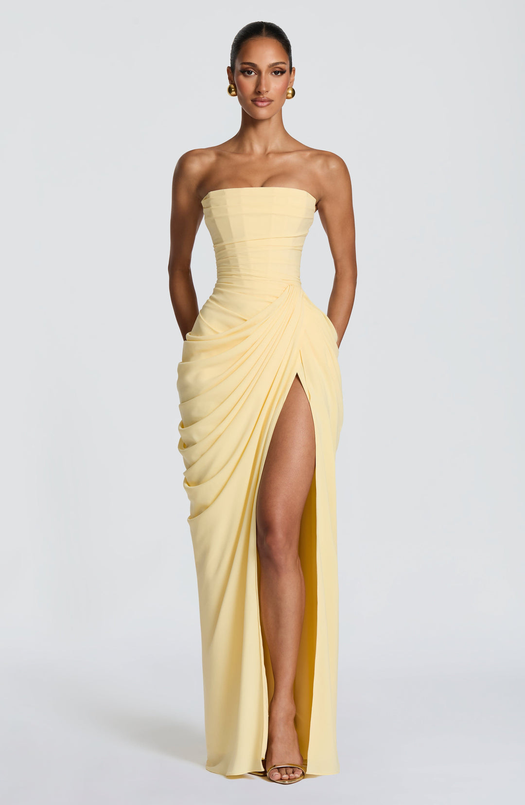 Sculpted fit strapless bodycon maxi dress, ideal for special occasions. Features a stylish corset top.