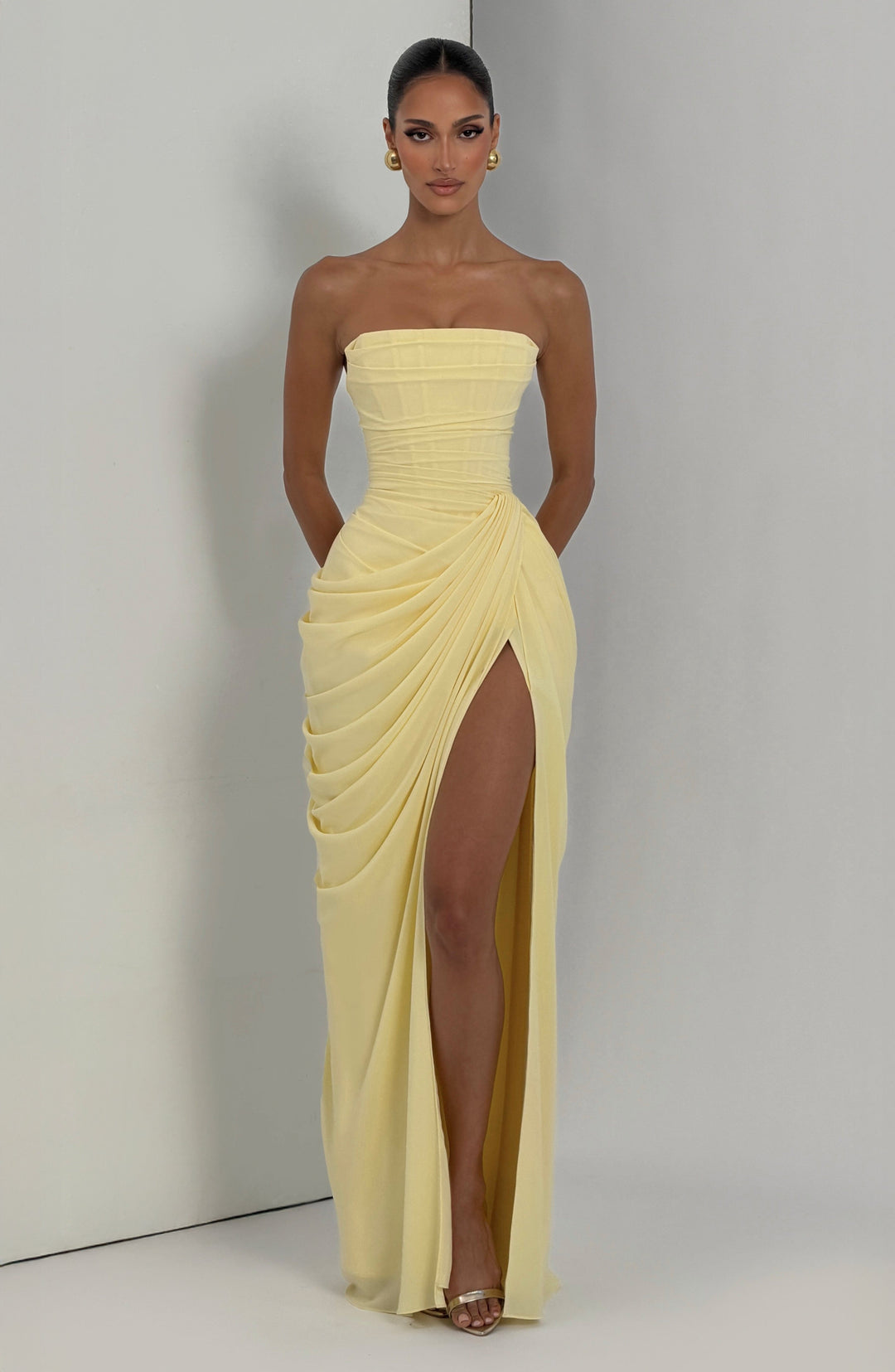 Sculpted women's strapless party dress; bodycon maxi style with a flattering corset top & leg slit.