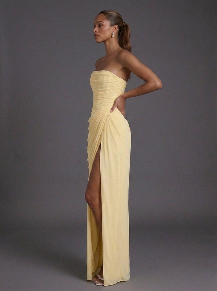 Elegant women's strapless maxi dress featuring a structured corset, ruched detailing, and a thigh-high split.