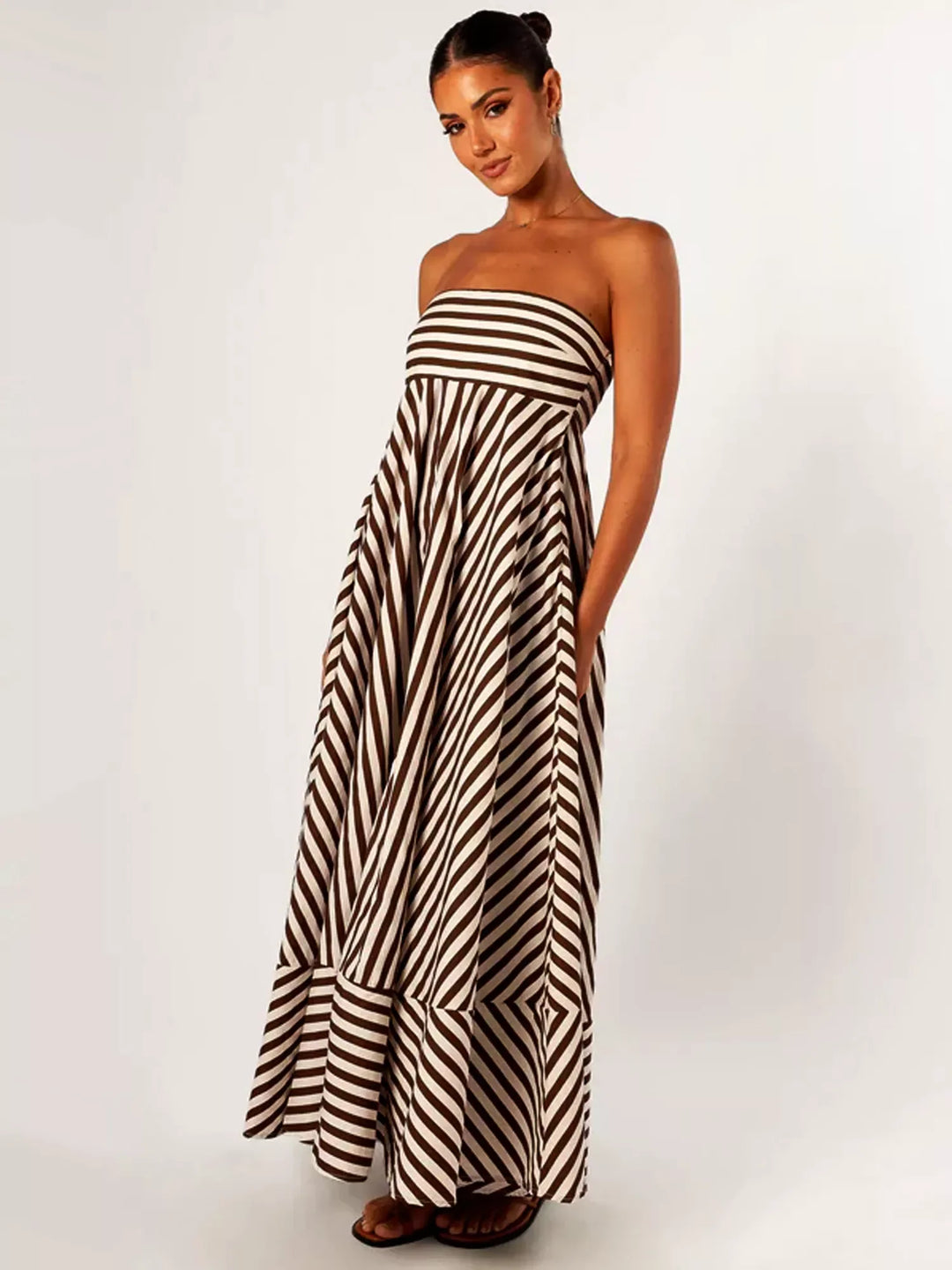 Flowing strapless maxi dress for women, with vibrant diagonal stripes, ideal for a breezy summer look.