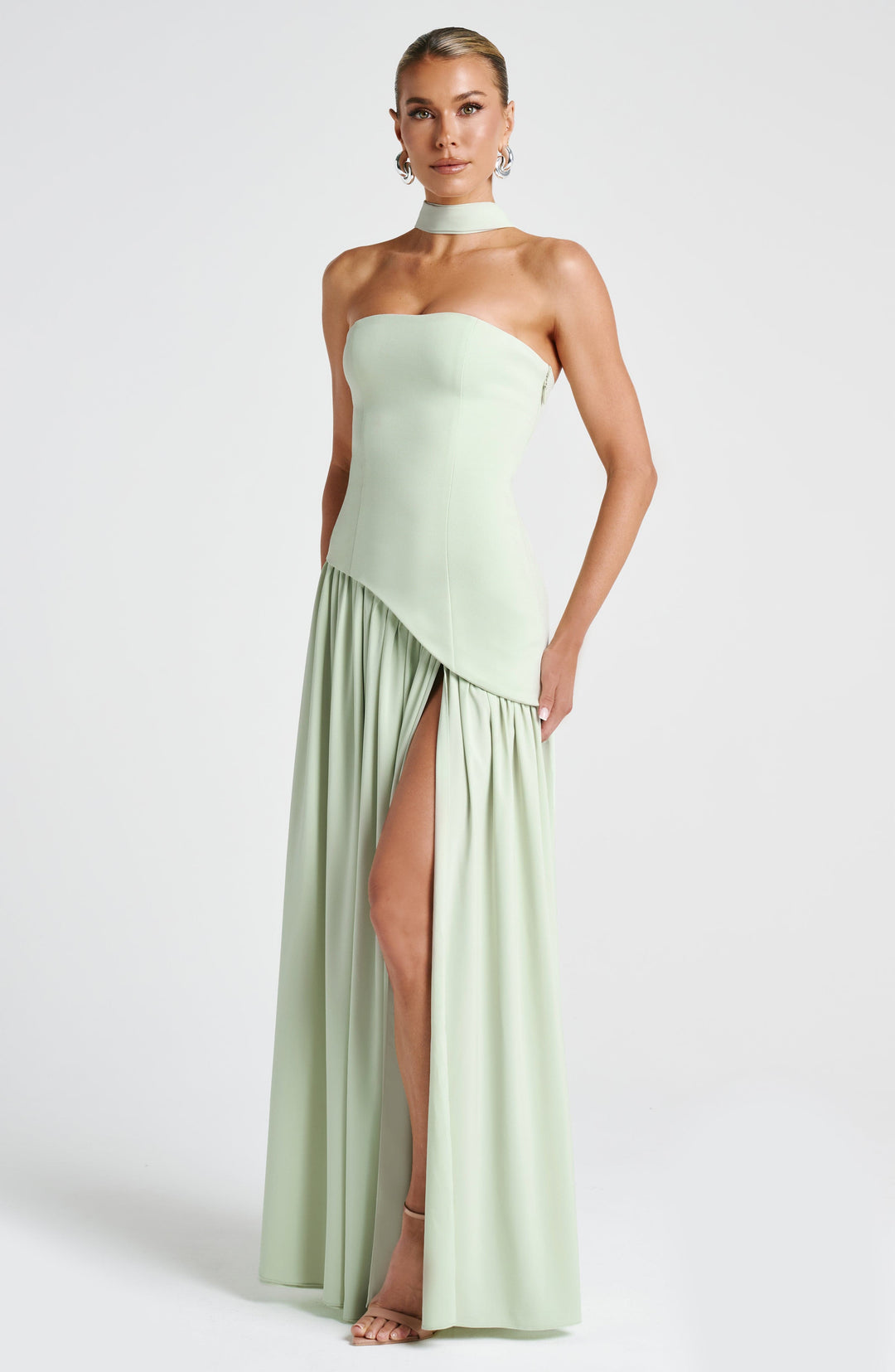 Statement strapless maxi dress with high slit & asymmetric waist. Elegant women's fashion for parties.