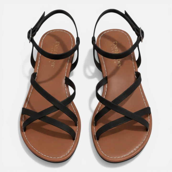 Classic brown women's flat sandals with intricate strappy details and an adjustable ankle buckle closure.