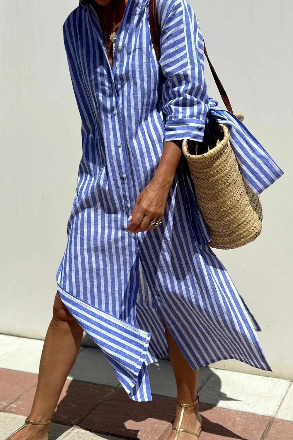 Detailed view of the buttons and classic collar on a women's striped casual button-down midi dress.