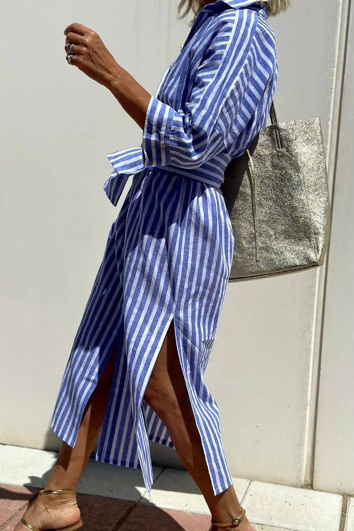Full length view of a woman wearing a chic striped button-down midi shirt dress, ideal for summer outfits.