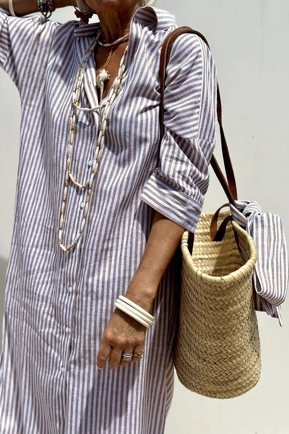 Fashionable striped button-down midi dress for women, featuring a smart collar for casual summer elegance.
