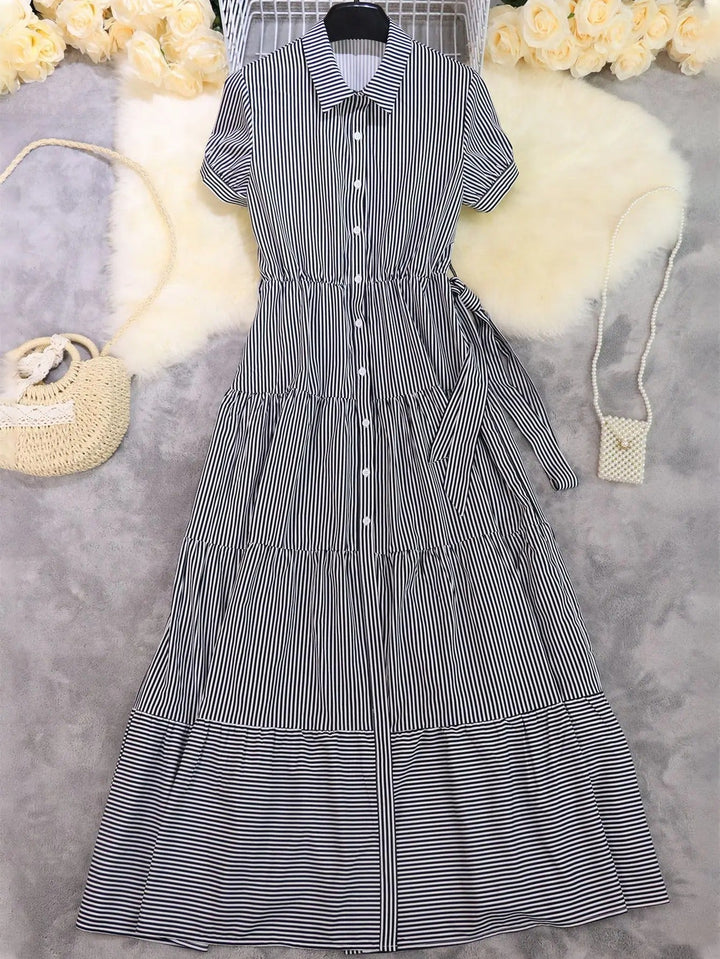 Flowy striped tiered maxi dress for women. Button-down front, polo collar & tie waist for a chic summer look.