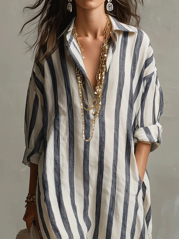Elegant women's striped midi shirt dress with a flattering V-neck, flowy skirt, and practical three-quarter sleeves.