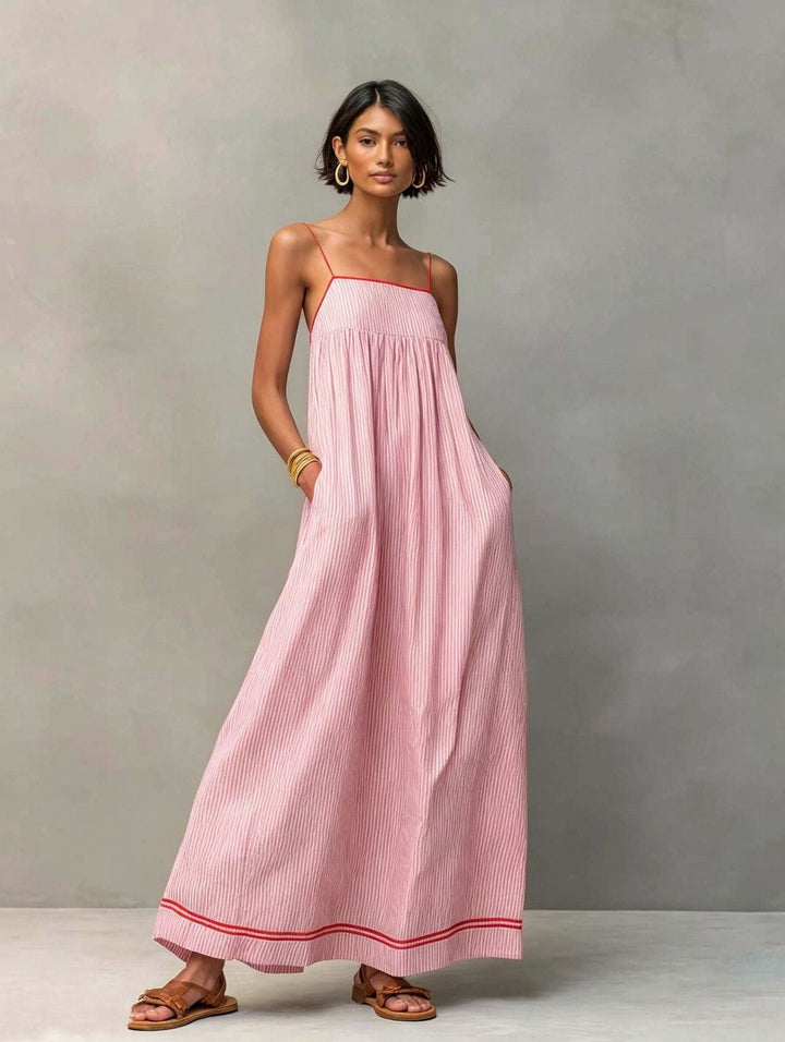 Comfortable striped sleeveless maxi dress with pockets, perfect for warm weather.