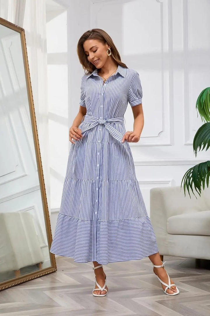 Elegant daywear: long striped dress for women, featuring ruffles, a tie waist, and button-down style.