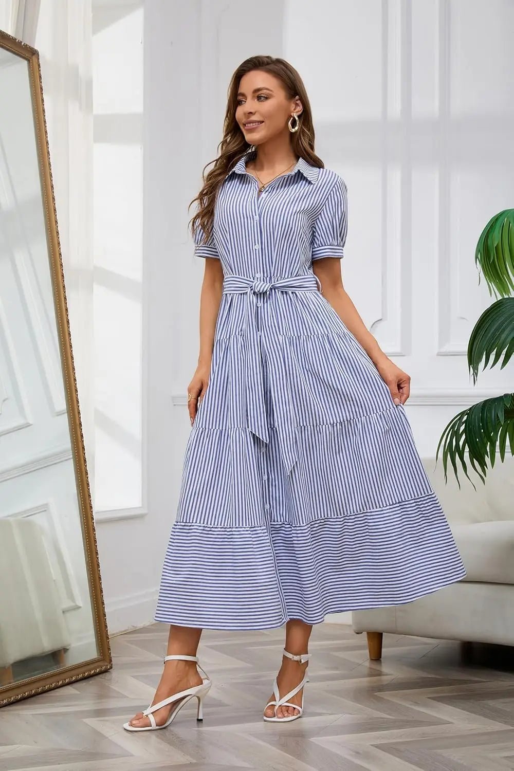 Long women's striped dress with ruffles, tie-waist, and full button-down design for elegant daywear.