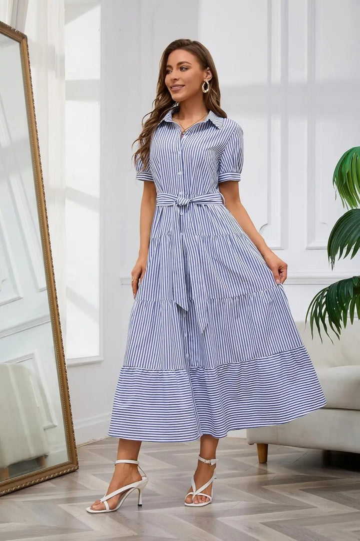 Long women's striped dress with ruffles, tie-waist, and full button-down design for elegant daywear.