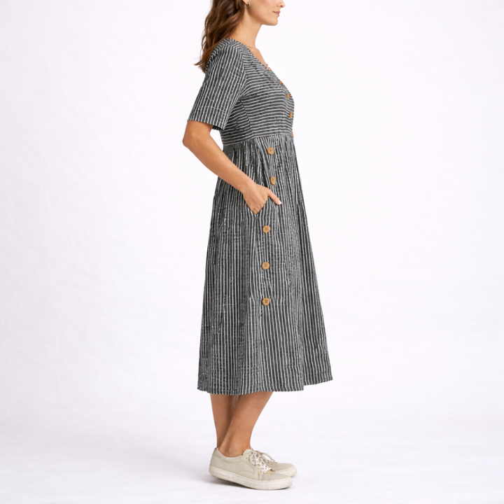 Elegant women's striped midi dress with a flattering fit, scoop neck, short sleeves, and practical side pockets.