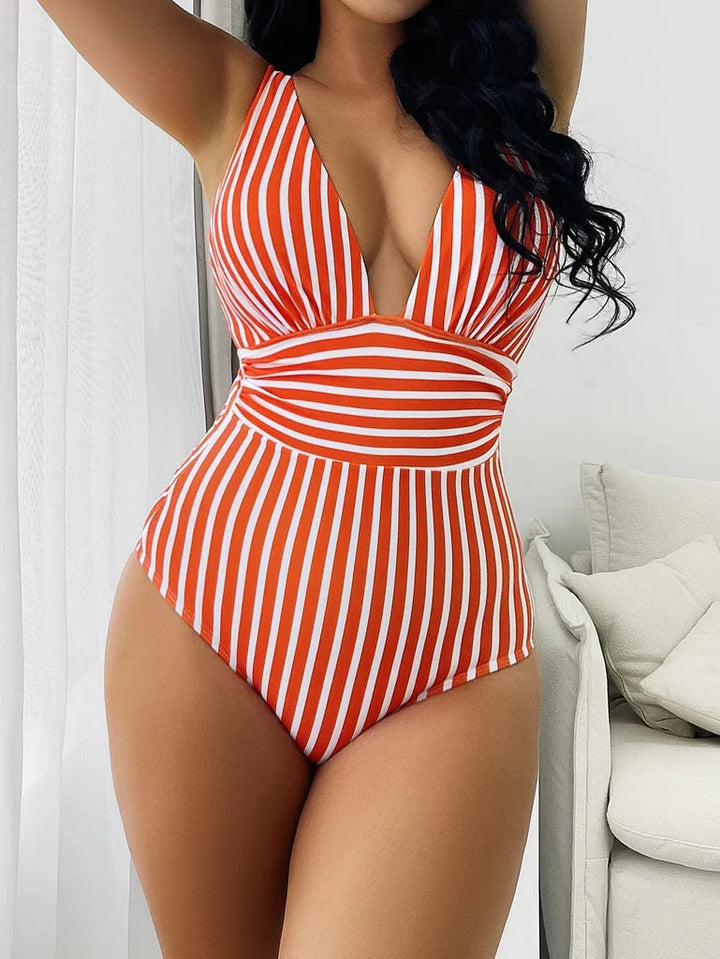 Stylish women's striped V-neck swimsuit, a chic one-piece for flattering summer beach and poolside vacation wear.