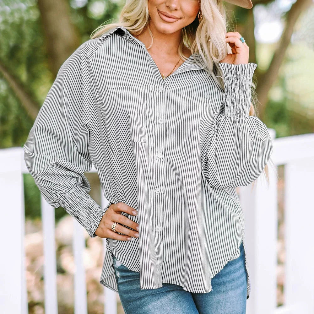 Elegant women's striped oversized button-down shirt with balloon sleeves, great for spring/summer fashion.