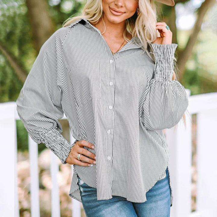 Elegant women's striped oversized button-down shirt with balloon sleeves, great for spring/summer fashion.