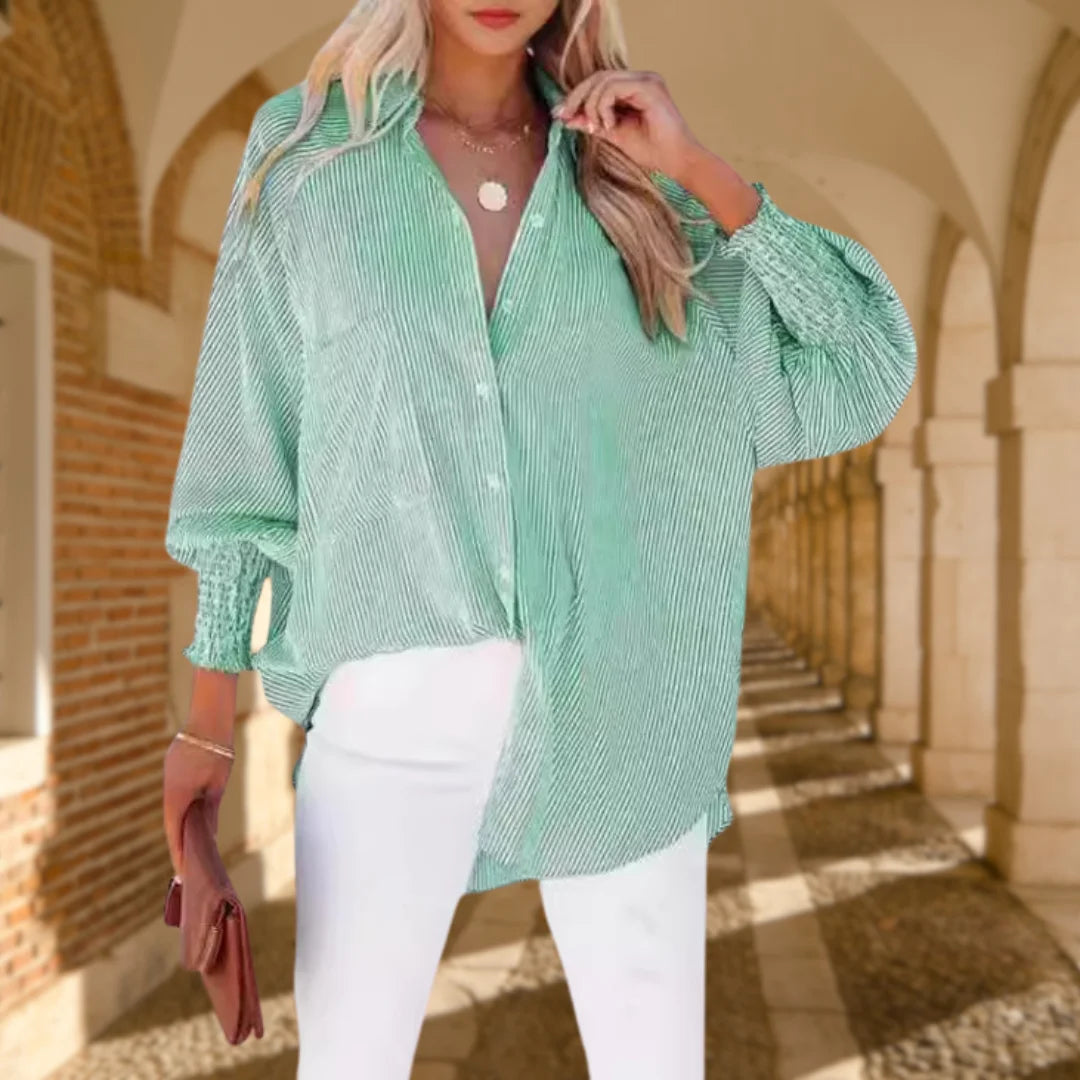 Fashionable women's oversized striped button-down top with elegant shirred balloon sleeves for spring style.