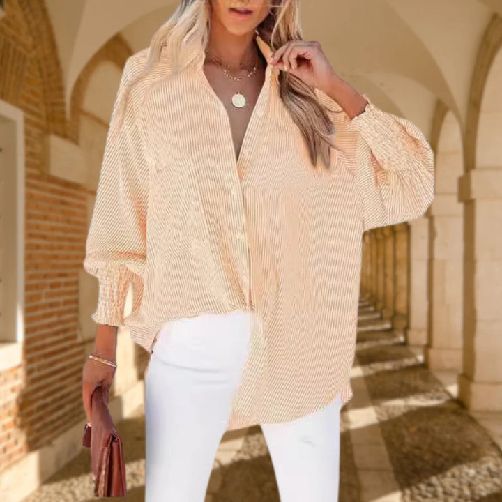 Casual chic women's striped oversized button-down shirt, highlighting the unique shirred balloon sleeves.