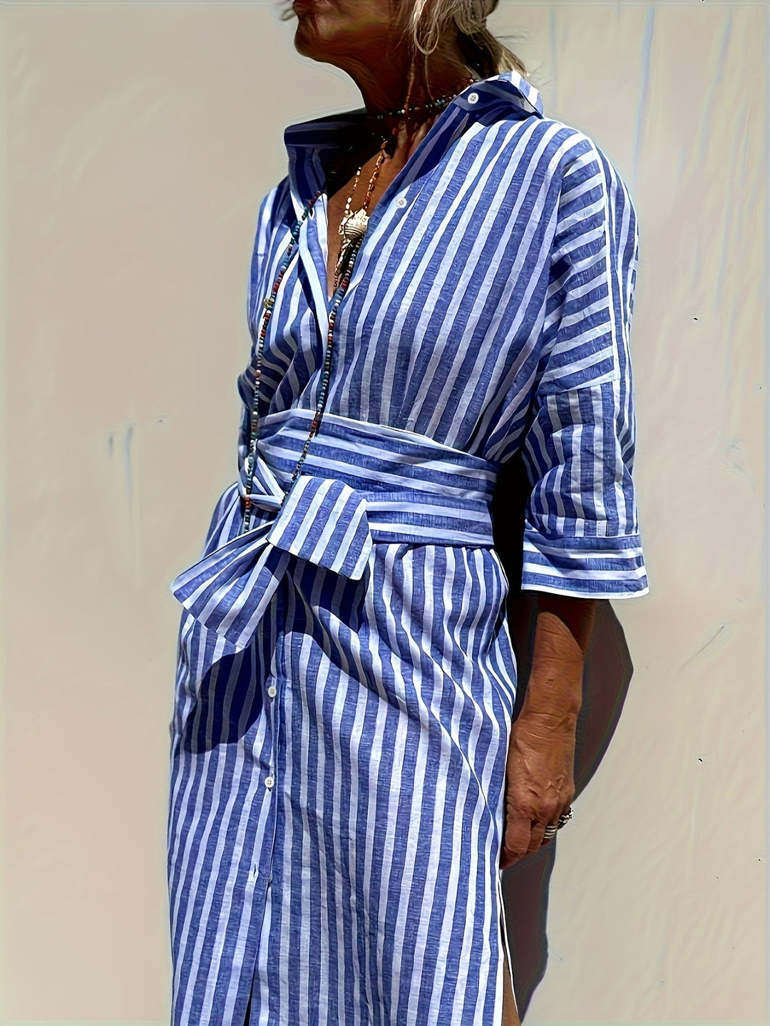 Women's striped shirt dress with belt, button closure & three-quarter sleeves.