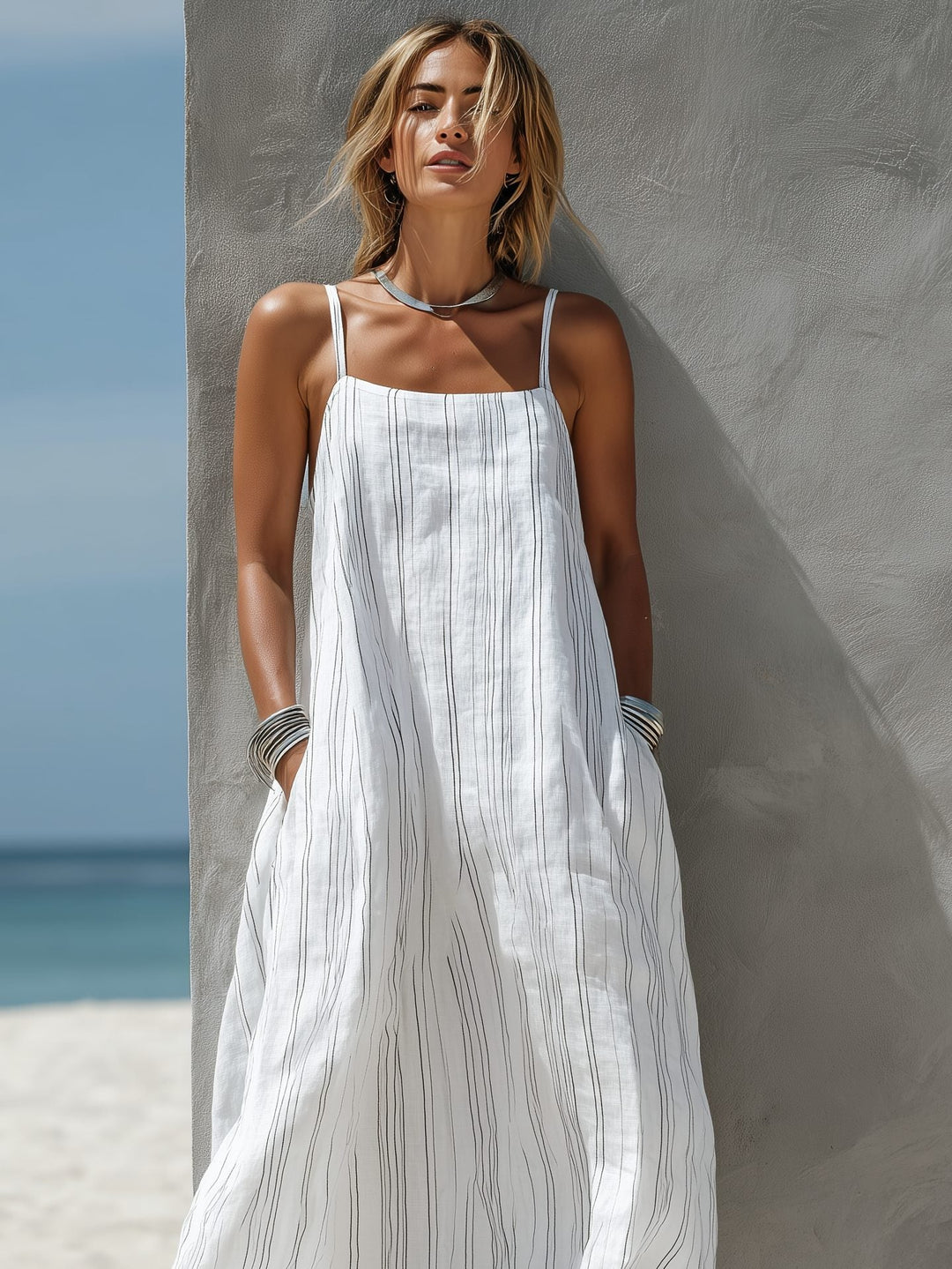 Elegant women's sleeveless striped maxi dress, ideal for summer vacation, beachwear, or casual everyday style.