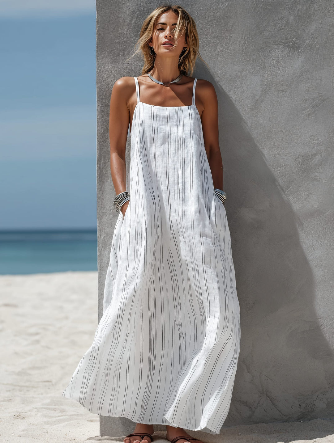 Comfortable women's flowing sleeveless striped maxi dress, a chic choice for beachwear and summer casual outfits.