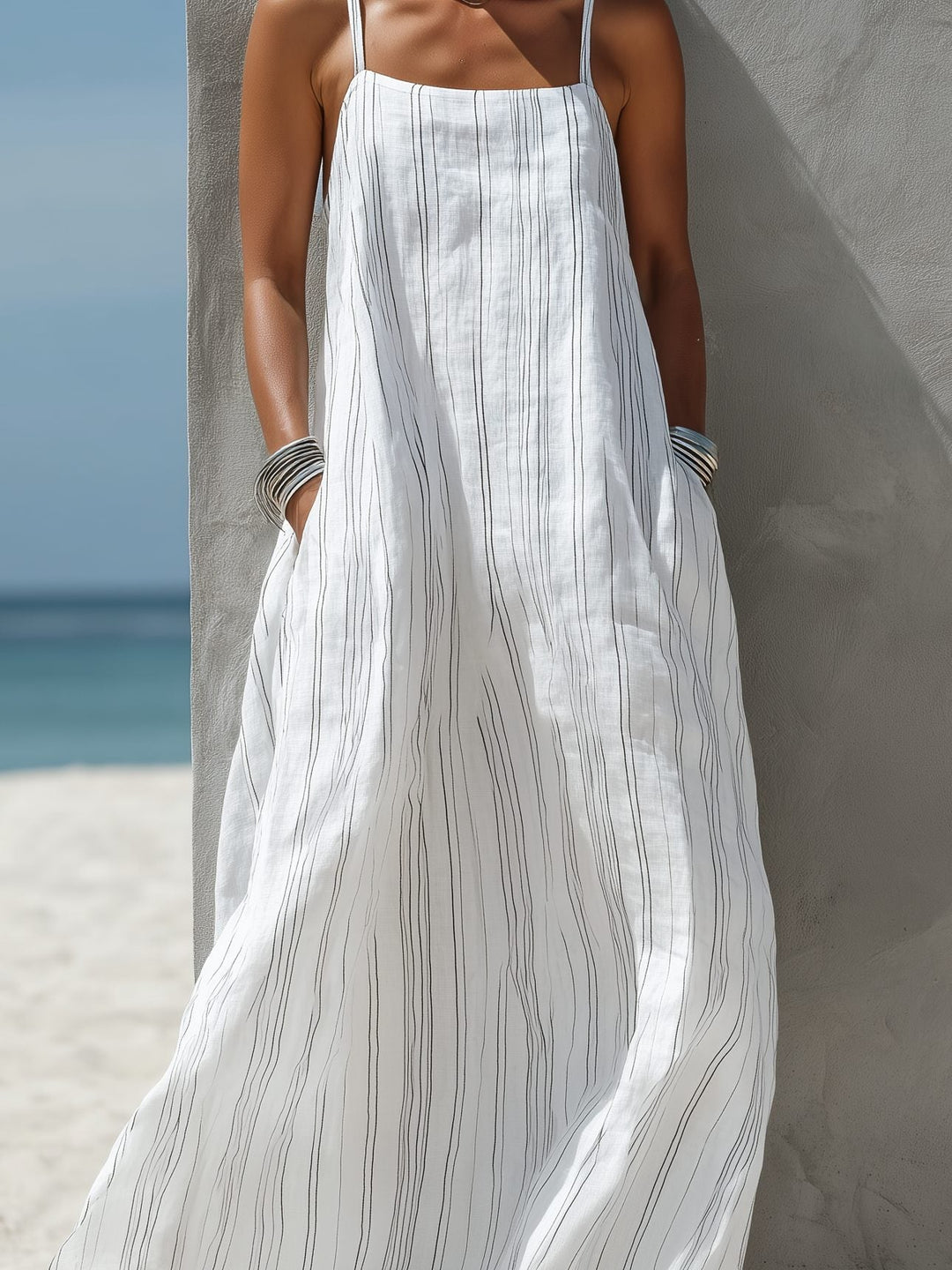 Stylish women's striped sleeveless maxi dress, perfect for warm weather, a summer fashion essential and vacation dress.