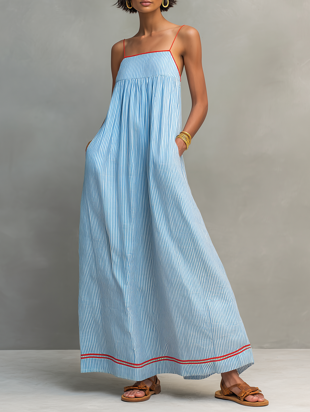 Women's striped sleeveless maxi dress with a flattering gathered waist detail, ideal for summer fashion.