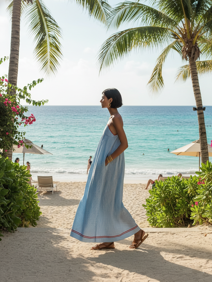 Casual women's striped sleeveless maxi dress with chic gathered detail, a versatile summer fashion staple.