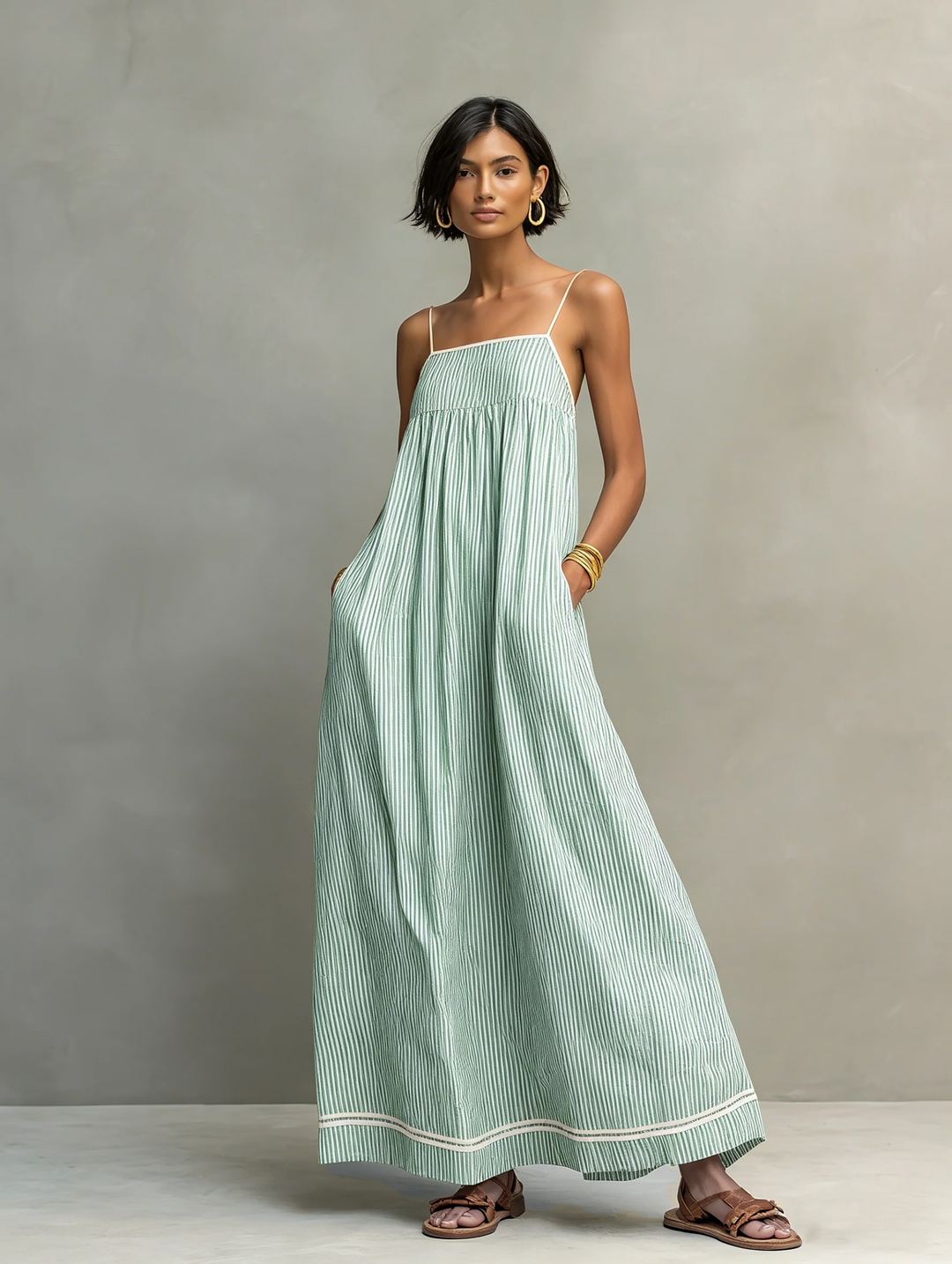 Holiday-ready women's striped sleeveless maxi dress with a beautiful gathered silhouette, great for vacations.