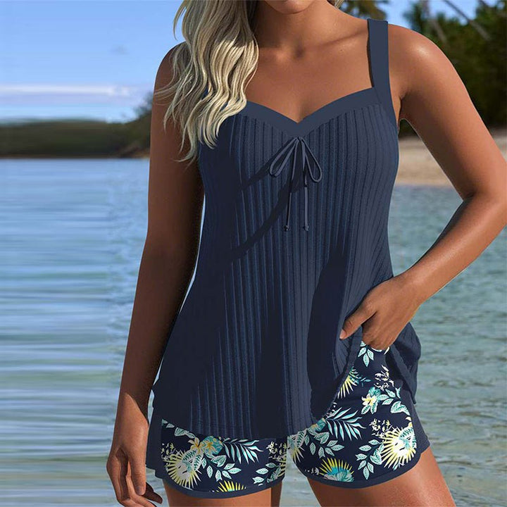 Women's striped two-piece tankini swim set with tummy control top and matching beach shorts for summer.