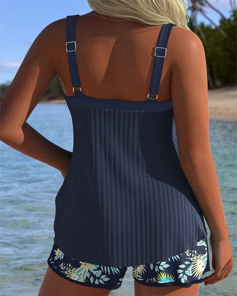 Stylish women's striped tankini top and coordinating beach shorts, a comfortable two-piece swimsuit for poolside.