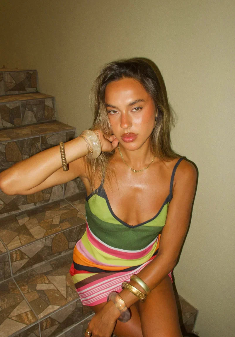 Stylish striped V-neck mini dress for women. Features delicate spaghetti straps and a flattering cut for fashion.