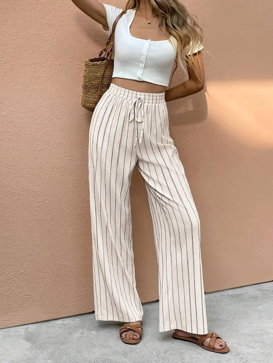 Women's striped wide leg linen trousers with elasticated drawstring waist, perfect for summer casual & holiday wear.