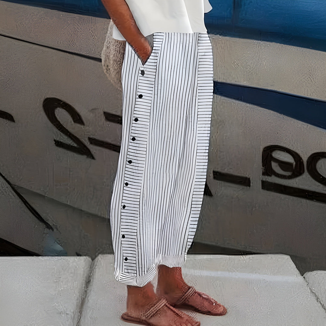 Flowy women's high-waisted striped wide leg trousers, featuring unique side buttons; ideal for casual elegance.