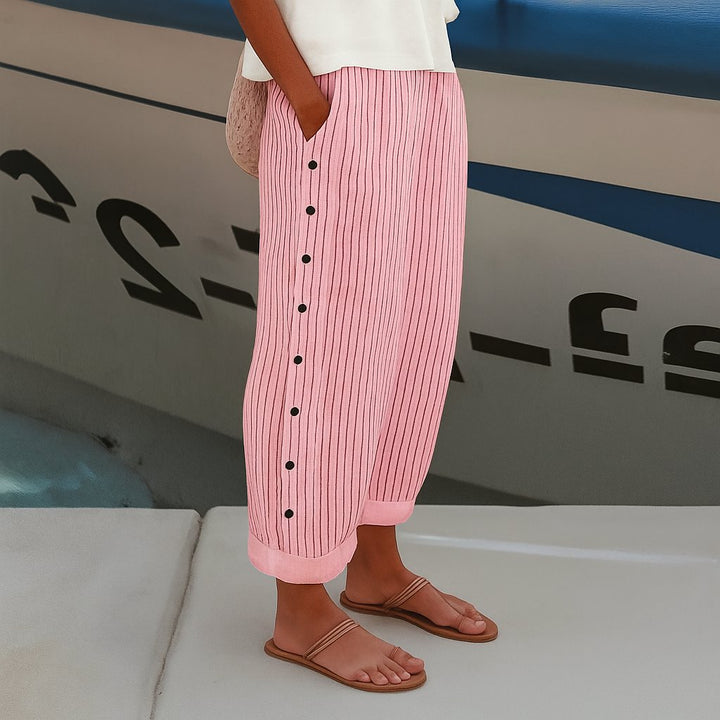 Chic women's striped wide leg trousers, high-waisted and comfortable, with distinctive side button detailing.