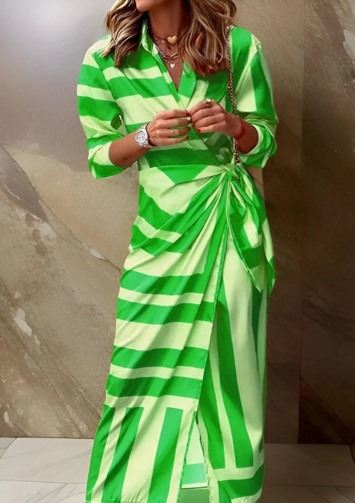 Full view of a woman wearing a striped wrap midi long sleeve dress, showcasing its flattering fit.