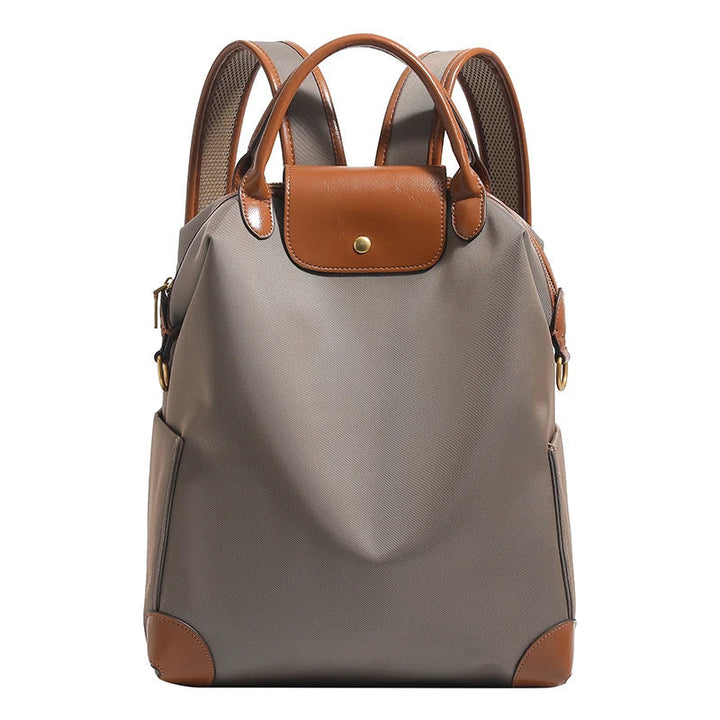 Navy blue women's structured backpack, featuring leather trim, a spacious and durable everyday travel bag.