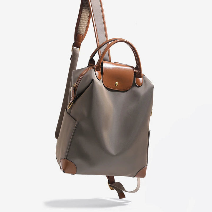 Spacious women's structured everyday backpack with elegant leather trim, ideal for travel & daily use.