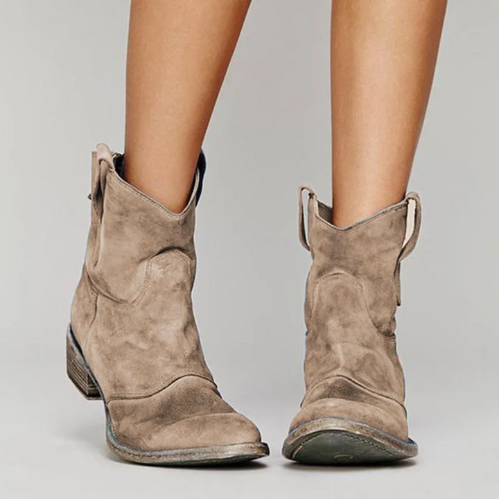 Women's stylish ankle western boots with pull tabs. Comfortable low heel for everyday casual wear.