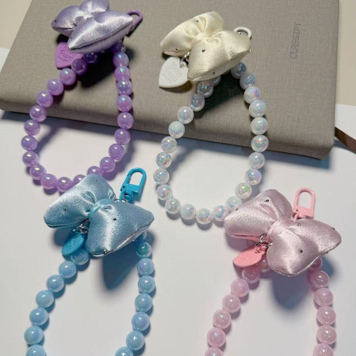 Women's stylish beaded keychain with an elegant bow, perfect key holder or chic bag charm accessory.