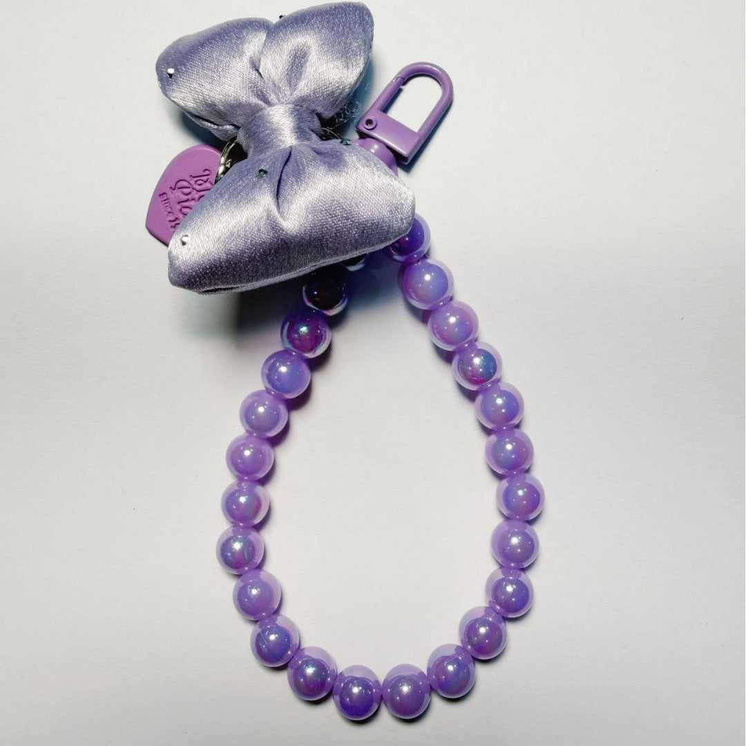 Beaded bag charm keychain for women, with a chic bow, adding sophisticated style to any purse.