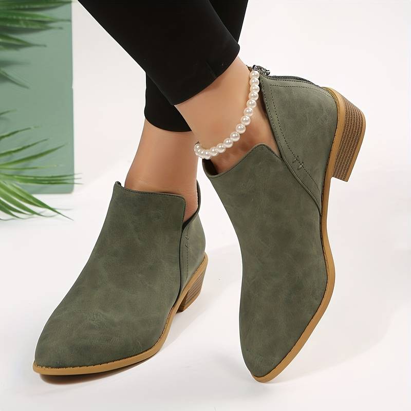 Women's stylish black ankle boots with a low heel, pointed toe, & comfortable design, perfect for everyday wear.