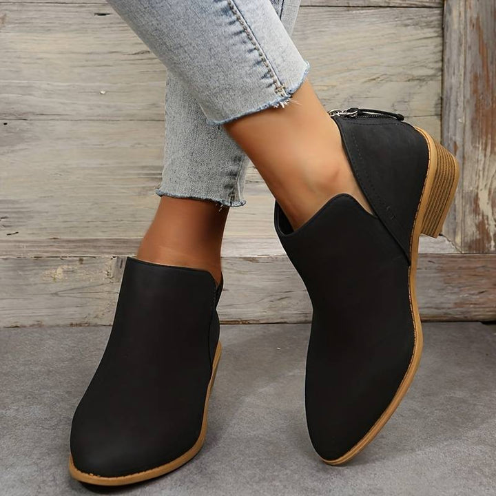 Stylish women's footwear: ankle boots with a chic pointed toe and practical low heel, ideal for winter fashion.