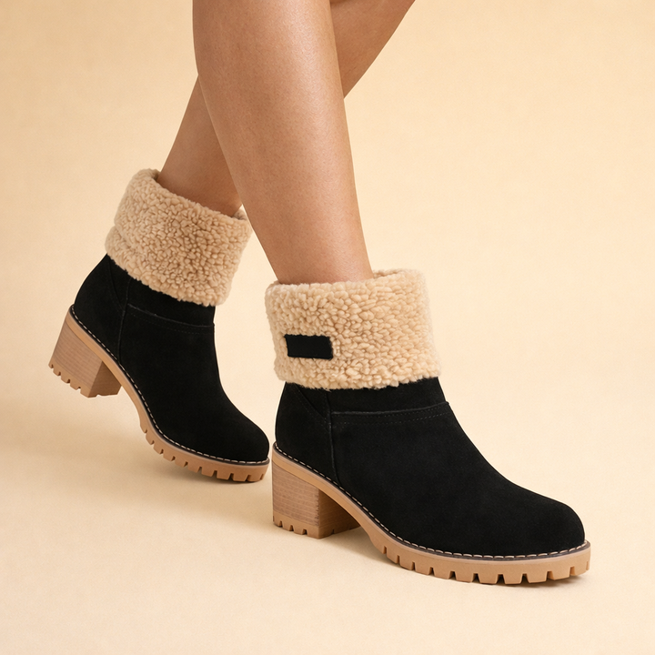 Women's stylish black mid-tube winter snow boots with warm faux fur lining, perfect for cold weather comfort.