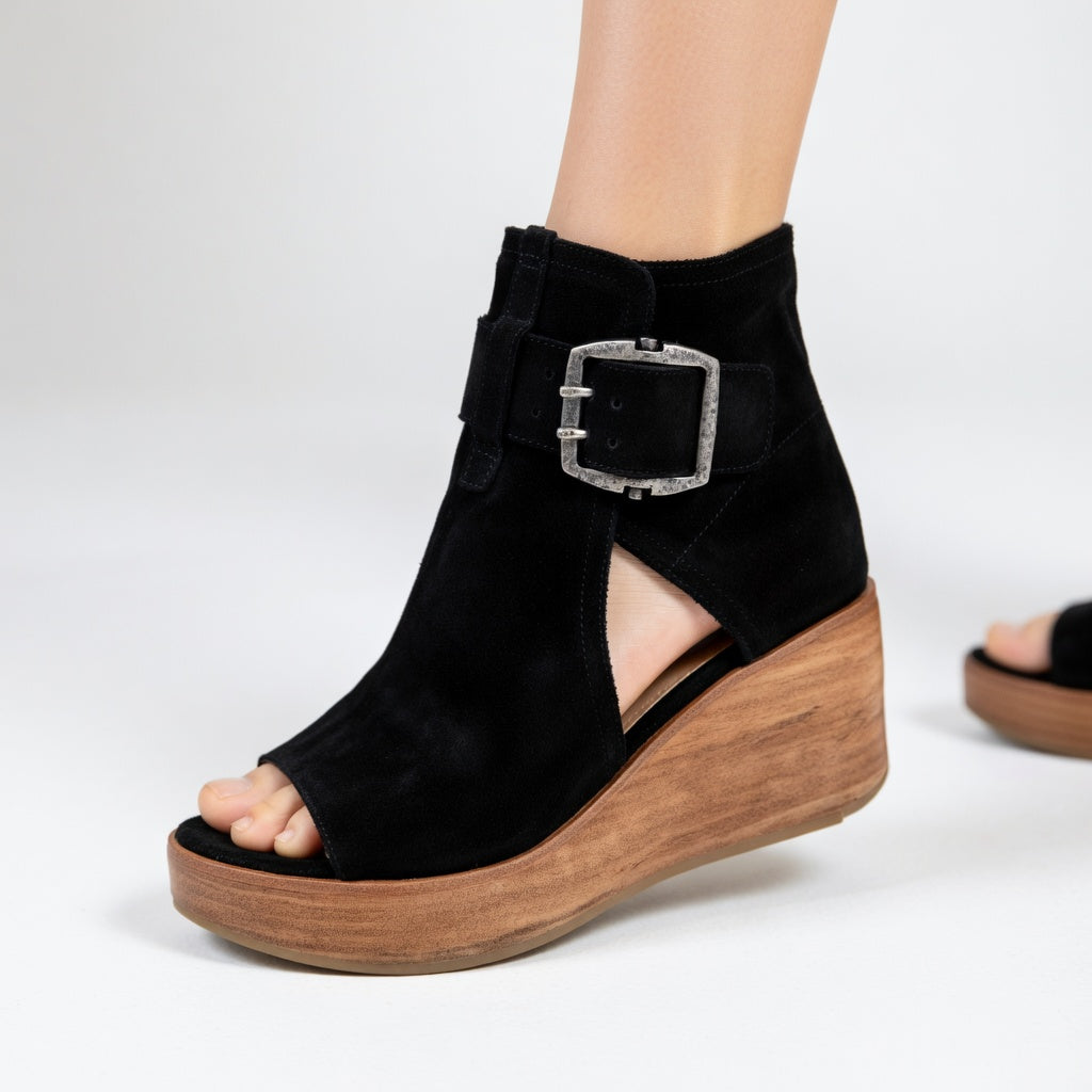 Elegant purple open-toe wedge ankle boots for women. Stylish and comfortable, perfect for casual or dressy outfits.