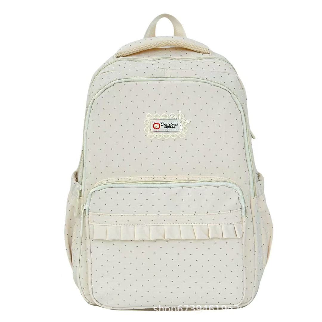 Women's stylish black polka dot ruffled backpack, perfect for school or casual use.