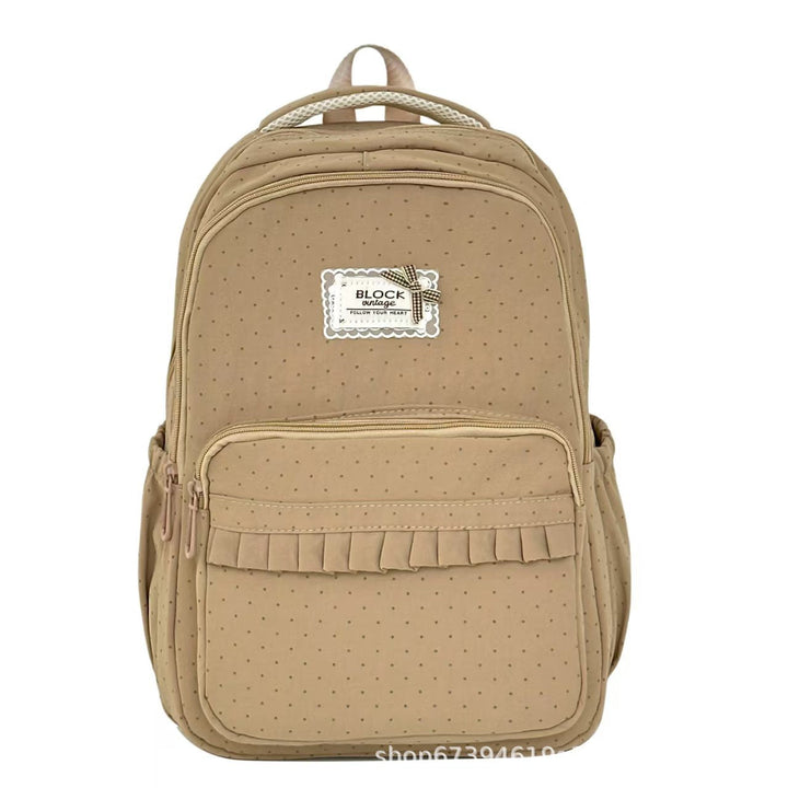 Cute women's polka dot ruffled backpack with durable design, great for travel and daily wear.