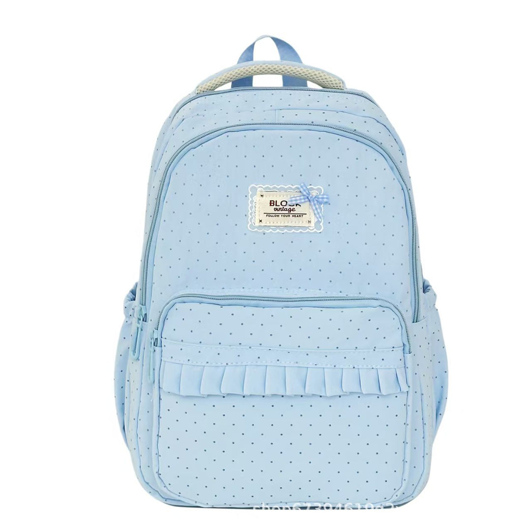 Elegant ruffled polka dot backpack for women, a stylish accessory for school or casual outings.