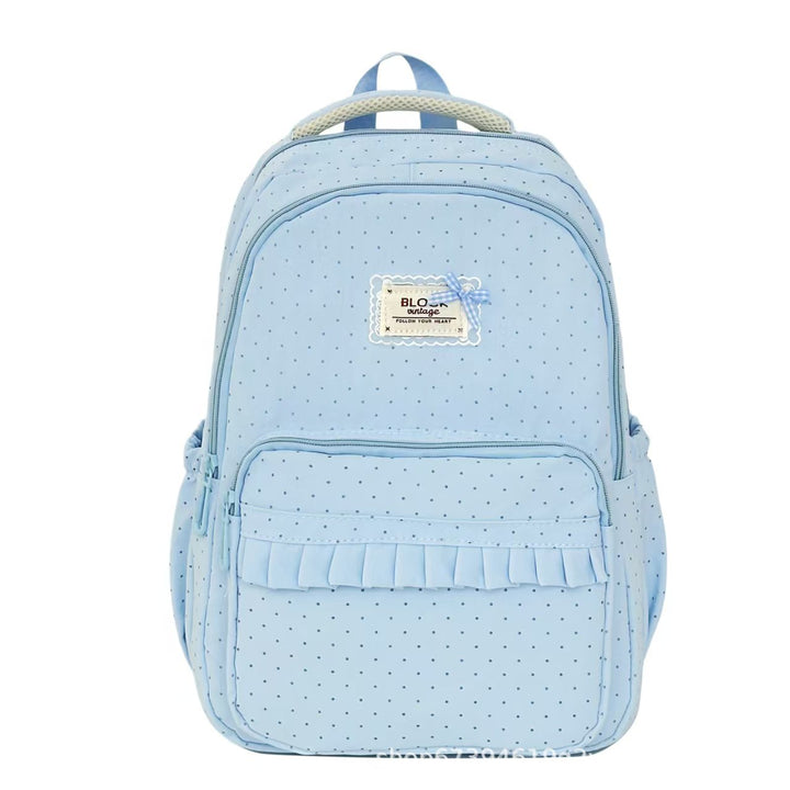 Elegant ruffled polka dot backpack for women, a stylish accessory for school or casual outings.
